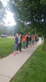 image of people waving and lining a sidewalk